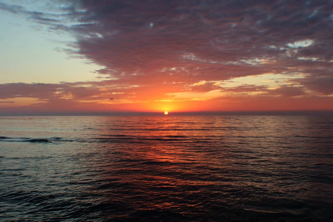 Golden sunrise over a calm ocean horizon
